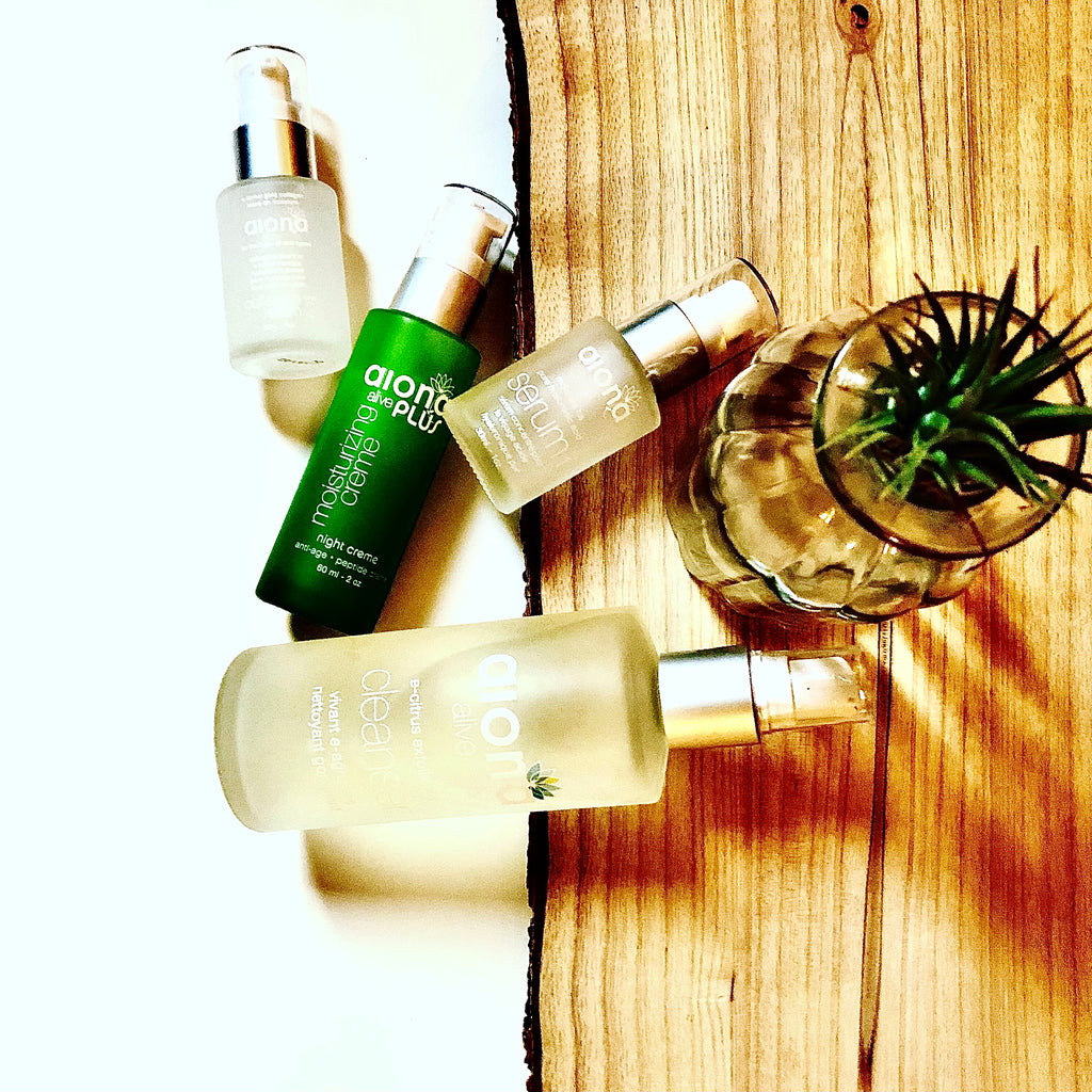 Glass bottles with serums on a wood board